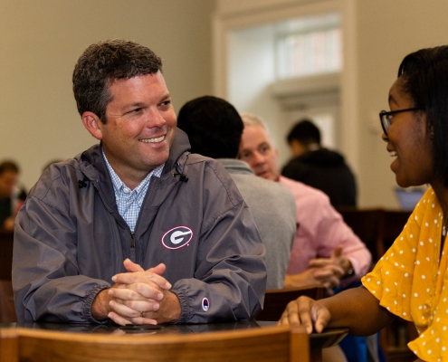 UGA alumni interacts with current student.